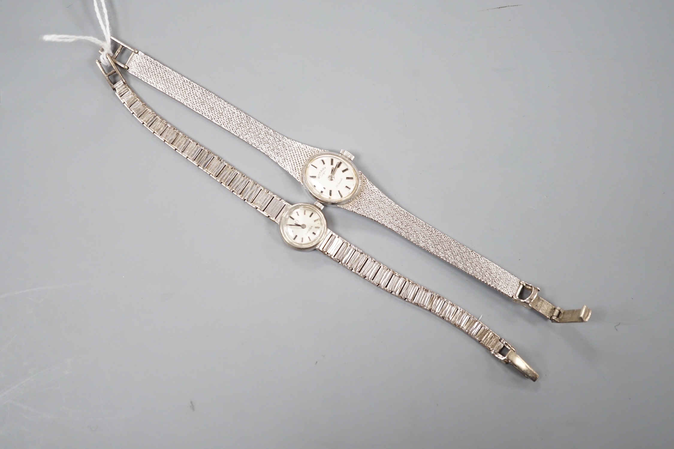 A lady's 9ct white gold Rotary manual wind wrist watch and a similar Omega wrist watch, gross 31.5 grams.